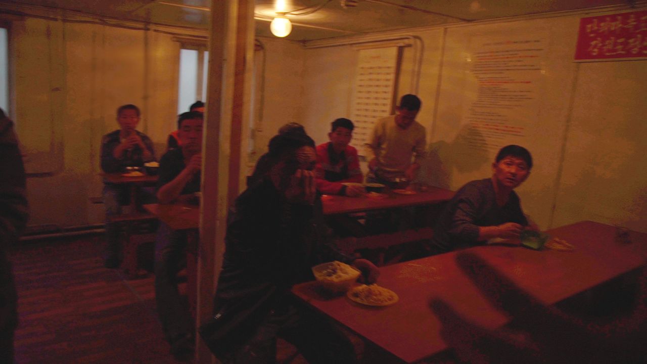 North Korean workers eat lunch in their canteen.