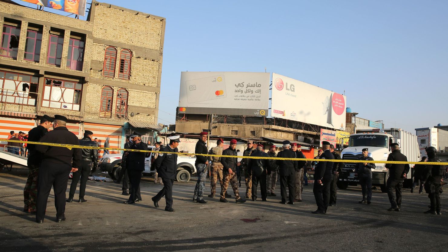 Iraqi security forces cordon off an area in central Baghdad after a deadly double suicide bombing on Monday.