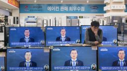A live broadcast shows South Korea's President Moon Jae-In delivering his New Year's address on television screens at an electronics mall in Seoul on January 10, 2018.
Denuclearisation of the Korean peninsula is "the path to peace and our goal", South Korean President Moon Jae-In said, a day after the North agreed to send its athletes to the Winter Olympics in his country. / AFP PHOTO / Ed JONES        (Photo credit should read ED JONES/AFP/Getty Images)