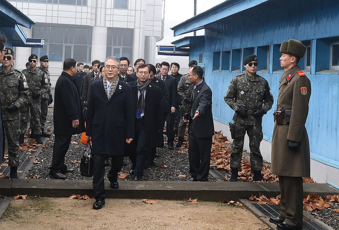 Lee Woo-sung, front, crosses into the North Korea side of the demilitarized zone dividing the two Koreas.