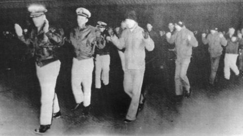 The USS Pueblo crew seen in a propaganda photo released by their captors after the ship was seized by North Korea. 