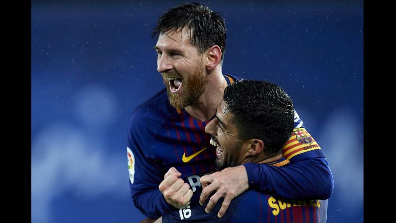 Barcelona's Lionel Messi celebrates with teammate Luis Suarez after scoring his team's fourth goal during the La Liga match against Real Sociedad on January 14.