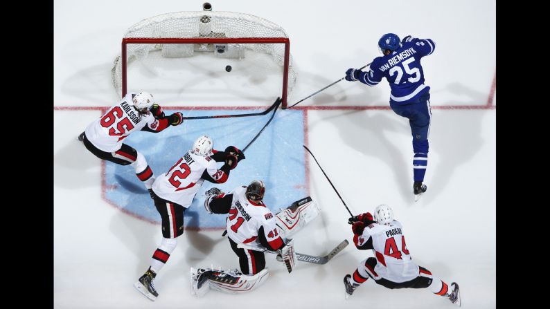 James van Riemsdyk of the Toronto Maple Leafs scores on Ottawa Senators players, from left, Erik Karlsson, Thomas Chabot, Craig Anderson, and Jean-Gabriel Pageau on January 10. The Senators ultimately defeated the Maple Leafs 4-3.