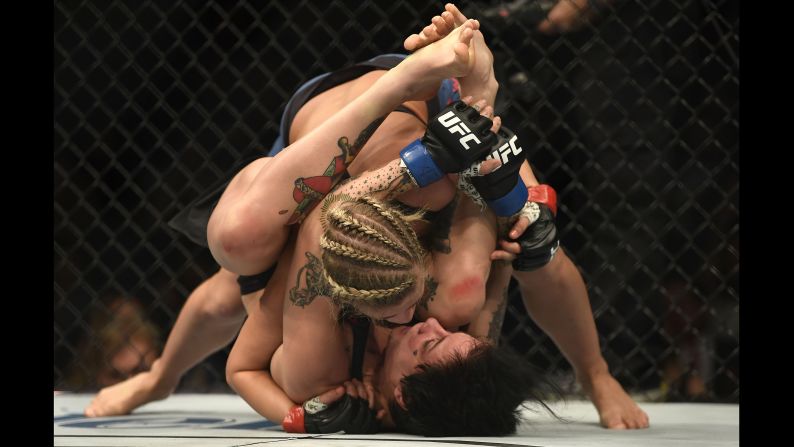 Paige VanZant (with braids) fights Jessica-Rose Clark during UFC Fight Night on January 14 in St. Louis.