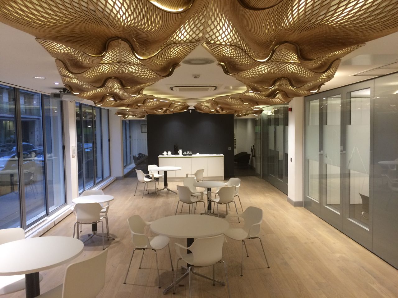 The Wooden Waves, designed by Mamou-Mani in 2015, is an architectural installation suspended in the entrance of the London offices of Buro Happold Engineering. It is made from flat, stock plywood, demonstrating that complex forms can be created using the most simple of materials.