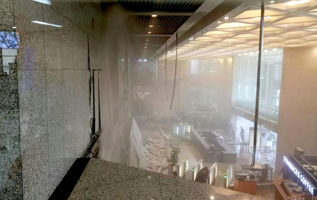 Photo shows dust still clouding the lobby after an internal balcony collapsed at Indonesia's stock exchange in Jakarta on January 15, 2018.