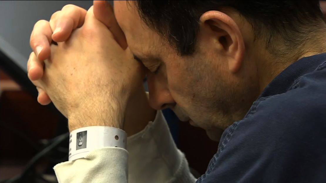 Larry Nassar rests his head on his hands Tuesday during his sentencing for seven counts of criminal sexual conduct.