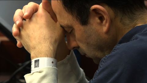 Larry Nassar rests his head on his hands Tuesday during his sentencing for seven counts of criminal sexual conduct.