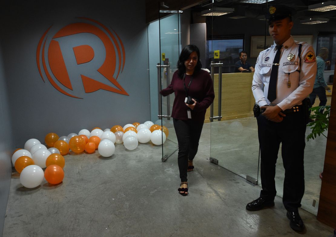 An employee of online portal Rappler heads out from their editorial office in Manila on January 15, 2018.