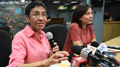 Rappler CEO and editor Maria Ressa speaks during a press conference at their office in Manila on January 15, 2018, while acting managing editor Chay Hofilena (R) listens. 