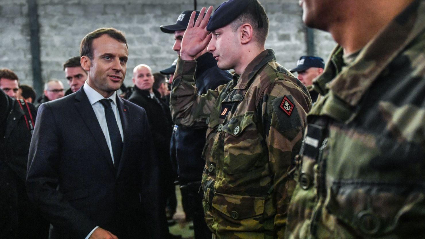 Emmanuel Macron meets security forces during his visit in the French northern city of Calais.