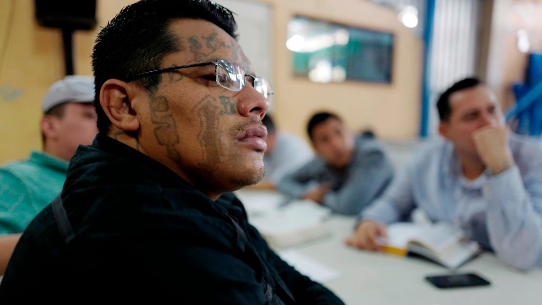 An ex-Barrio 18 gang member listens to a sermon at a church that welcomes former gang members into the congregation. 