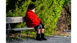 elderly woman sitting alone STOCK