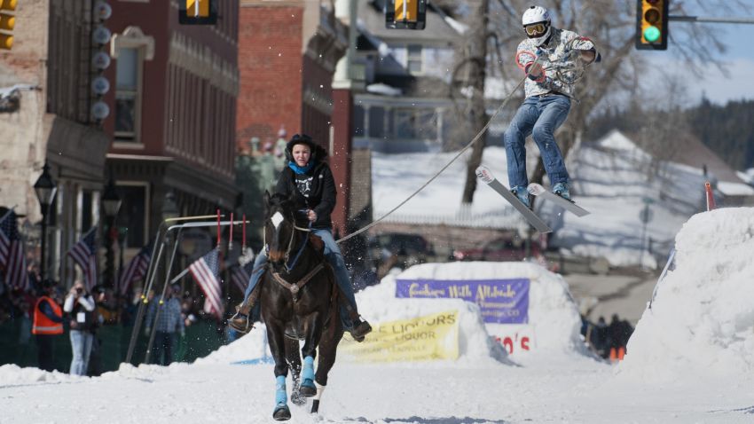Rider Savannah McCarthy races down Harrison Avenue while skier Mike Fries airs out off the final jump of the Leadville skijoring course during the 68th annual Leadville Ski Joring weekend competition on Saturday, March 4, 2017 in Leadville, Colorado. S
Skijoring, which has its origins as a competitive sport in Scandinavia, has been adapted over the years to include a team made up of a rider and skier who must navigate jumps, slalom gates, and the spearing of rings for points. Leadville, with an elevation of 10,152 feet (3,094 m), the highest incorporated city in North America, has been hosting skijoring competitions since 1949. / AFP PHOTO / Jason Connolly        (Photo credit should read JASON CONNOLLY/AFP/Getty Images)
