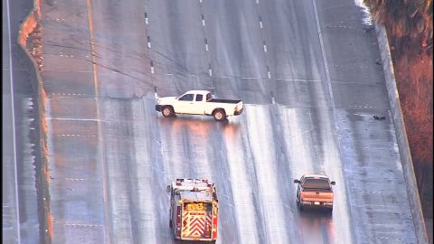 A pickup slides sideways on an icy patch Wednesday in Houston. The driver was able to regain control.