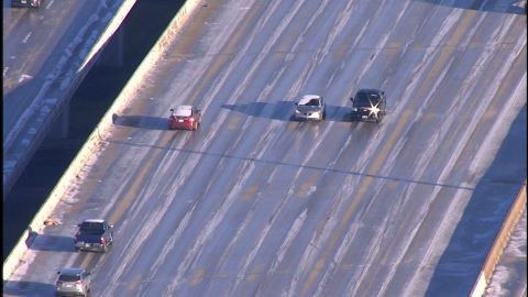 Drivers, left, intentionally head the wrong way Wednesday on a Houston highway to avoid a backup.