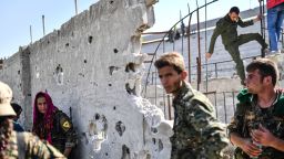 Fighters of the Syrian Democratic Forces (SDF) gather at the stadium in Raqa to celebrate on October 20, 2017, after retaking the city from Islamic State (IS) group fighters.
SDF fighters flushed jihadist holdouts from Raqa's main hospital and municipal stadium, wrapping up a more than four-month offensive against what used to be the inner sanctum of IS's self-proclaimed "caliphate", which for three years saw some of the group's worst abuses and grew into a centre for both its potent propaganda machine and its unprecedented experiment in jihadist statehood. / AFP PHOTO / BULENT KILIC        (Photo credit should read BULENT KILIC/AFP/Getty Images)