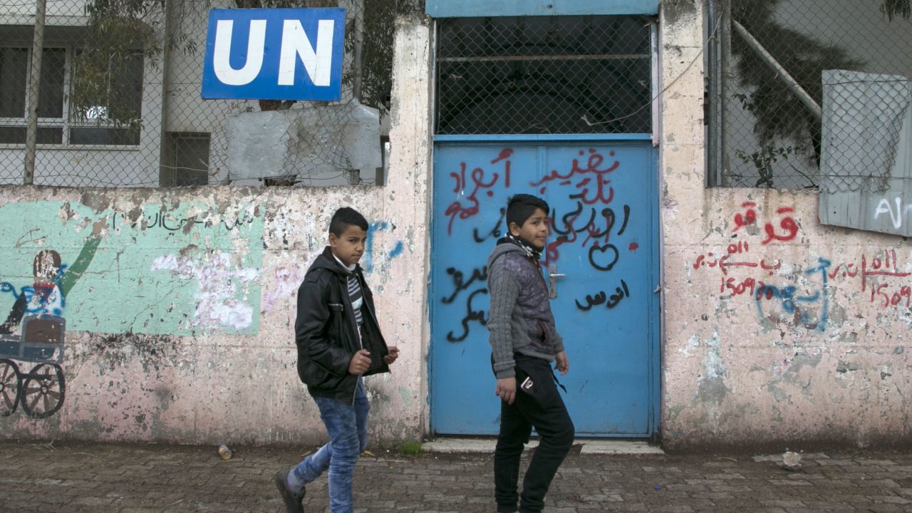 Palestinian children walk outside the Askar refugee camp, near Nablus in the West Bank, in January 2018.