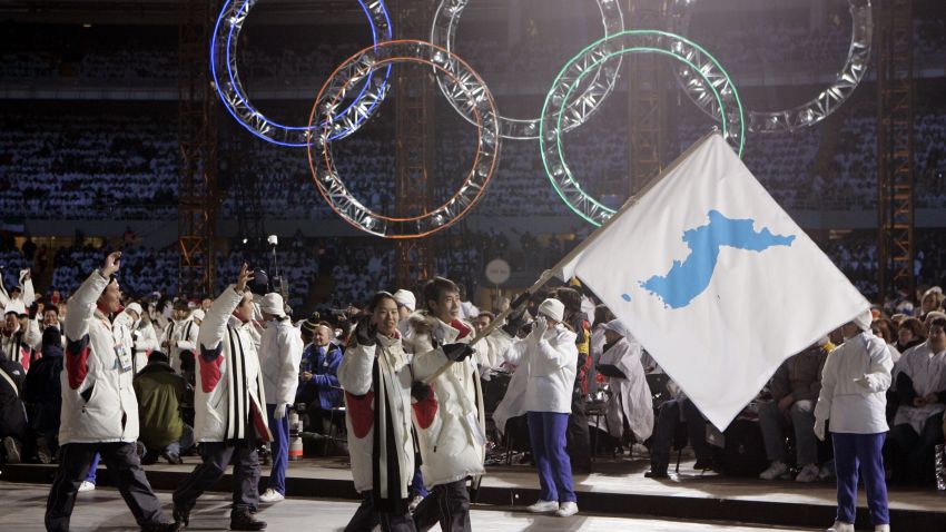 FILE - In this Feb. 10, 2006, file photo, Korea flag-bearer's Bora Lee and Jong-In Lee, carrying a unification flag lead their teams into the stadium during the 2006 Winter Olympics opening ceremony in Turin, Italy. North Korea plans to send a spotlight-stealing delegation to next month's Winter Olympics in the South Korean county of Pyeongchang. (AP Photo/Amy Sancetta, File)