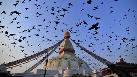 <strong>Boudhanath Stupa, Kathmandu, Nepal:</strong> Pigeons fly above the UNESCO heritage site of Boudhanath Stupa, in Kathmandu, Nepal.