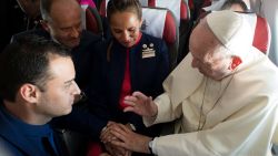 Pope Francis marries flight attendants Carlos Ciuffardi, left, and Paola Podest, center, during a flight from Santiago, Chile, to Iquique, Chile, Thursday, Jan. 18, 2018. Pope Francis celebrated the first-ever airborne papal wedding, marrying these two flight attendants from Chile's flagship airline during the flight. The couple had been married civilly in 2010, however, they said they couldn't follow-up with a church ceremony because of the 2010 earthquake that hit Chile. (L'Osservatore Romano Vatican Media/Pool Photo via AP)