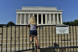 A child stands on the barricade around the Lincoln Memorial in Washington, DC, on October 2, 2013, on the second day of the federal government shutdown. AFP Photo/Jewel Samad        