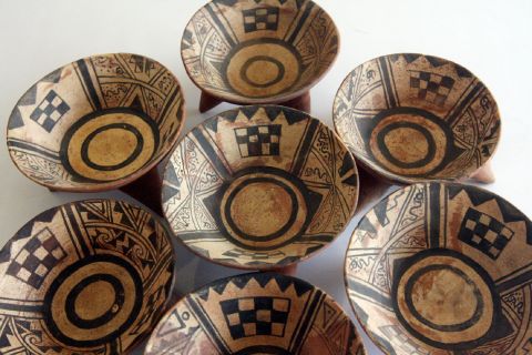 Most Moche vessels were decorated with symbolic shapes and patterns, painted red and black on a cream background. 