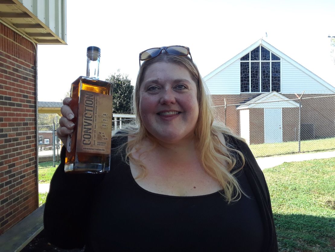 Area native and Southern Grace co-owner Leanne Powell holds up a bottle of Conviction, the distillery's bourbon.