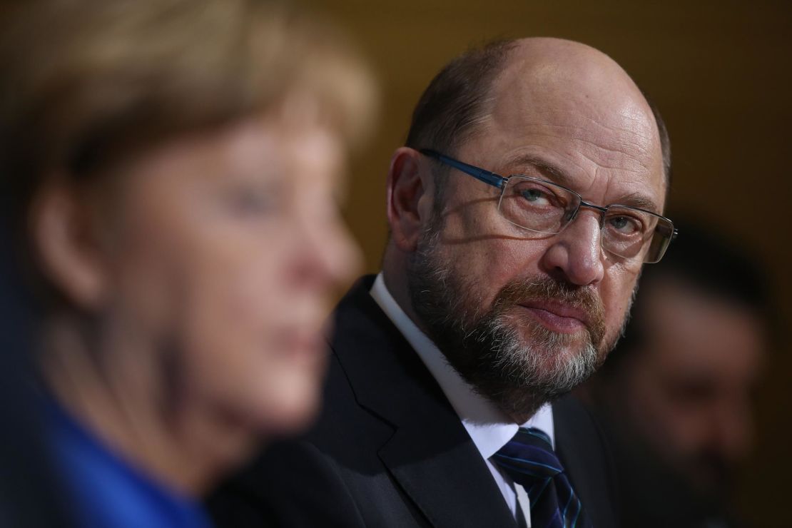 Angela Merkel and  Martin Schulz speak to the media following all-night talks on January 12, 2018 in Berlin.