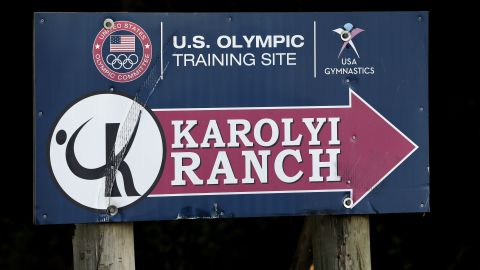 A sign points down the road to the Karolyi Ranch in New Waverly, Texas.