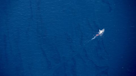 In this Jan. 15, 2018, aerial photo released by China's Xinhua News Agency, a boat moves through an oil slick on the surface of the East China Sea left by oil leaking from the sunken Iranian tanker ship Sanchi.