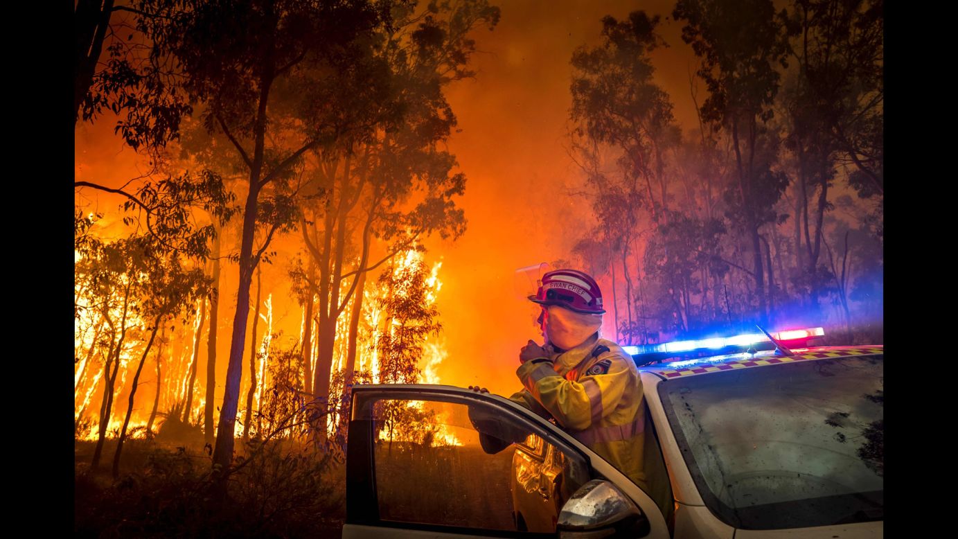 A firefighter monitors a bushfire on Sunday, January 14, in the eastern suburbs of Perth in Western Australia.<br />