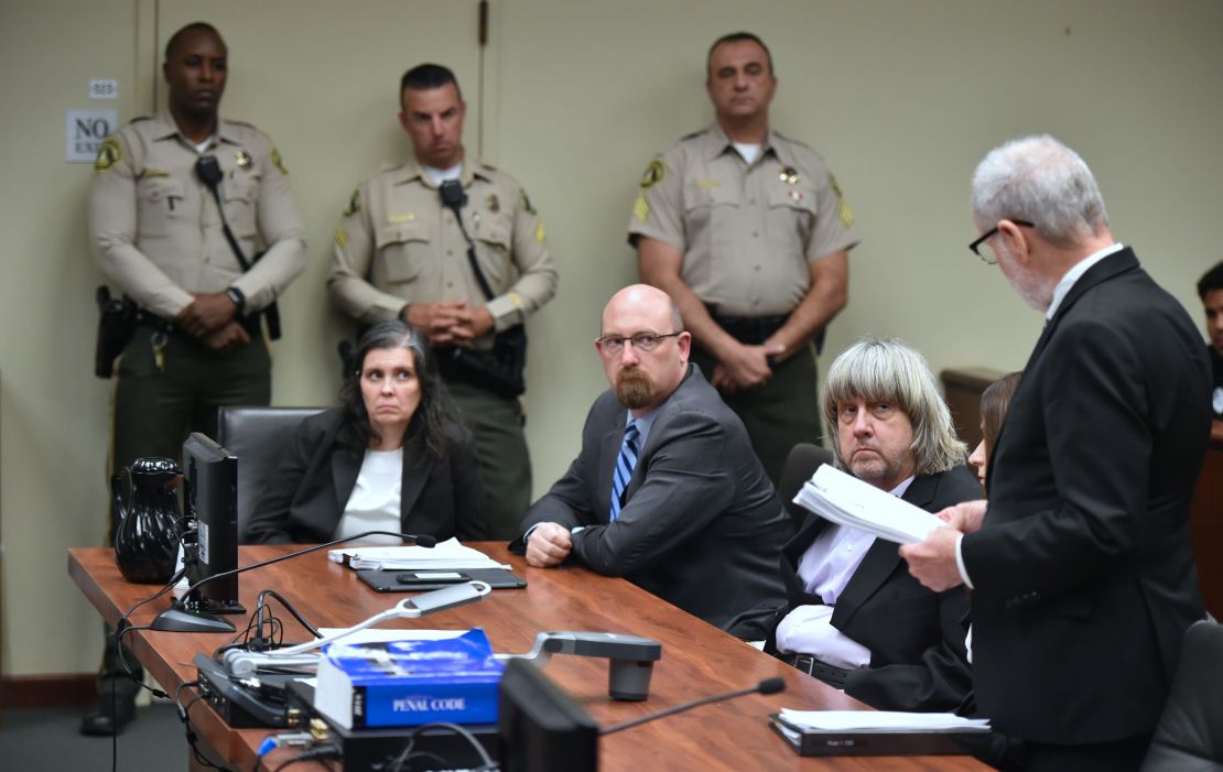 David (far right) and Louise Turpin look on Thursday with attorney Jeff Moore during the Turpins' arraignment.