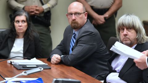 David (far right) and Louise Turpin look on Thursday with attorney Jeff Moore during the Turpins' arraignment.
