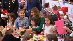First lady Melania Trump helps children make Christmas cards with the Marine Corps Reserve Toys for Tots Campaign at Joint Base Anacostia-Bolling in Washington, DC on December 13, 2017 / AFP PHOTO / MANDEL NGAN     