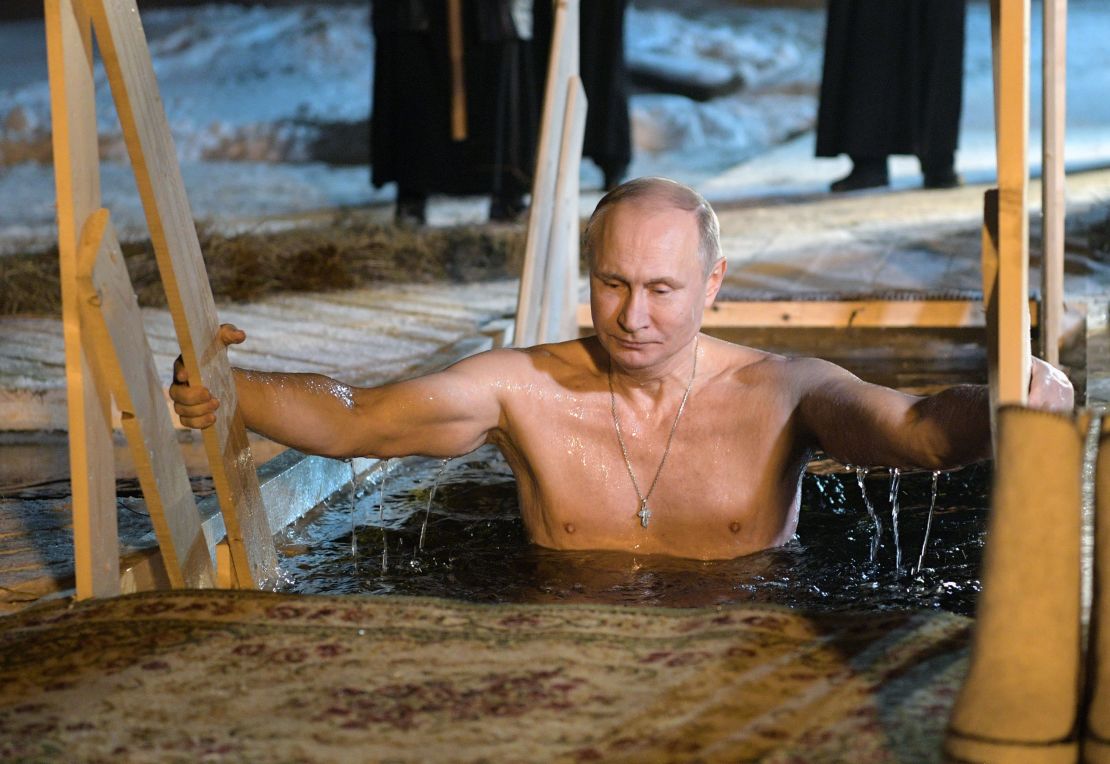 Russian President Vladimir Putin lowers himself into the icy waters of Lake Seliger.