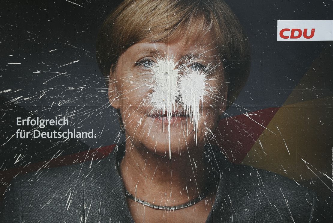 Chancellor Angela Merkel, pictured here on a vandalized campaign billboard, has struggled to build a new government since elections in September.