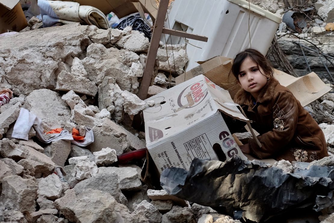 Five-year-old Ashwaq sits on the rubble of her former home in Mosul's old city 