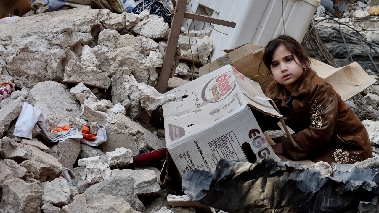 Five-year-old Ashwaq sits on the rubble of her former home in Mosul's old city