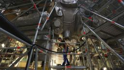 GREIFSWALD, GERMANY - OCTOBER 29:  A worker, at the photographer's request, walks on scaffolding under the Wendelstein 7-X experimental fusion reactor at the Max Planck Institute for Plasma Physics on October 29, 2013 in Greifswald, Germany. Scientists hope to heat a miniscule amount of hydrogen to 100 million degrees in order to melt the atomic cores into helium, thereby releasing large amounts of energy in a similar way as the sun. Due to be completed in 2014, the reactor could help scientists to get closer towards creating atomic fusion-based commercial power, which would be clean and virtually inexhaustible, as hydrogen comes from water.  (Photo by Sean Gallup/Getty Images)