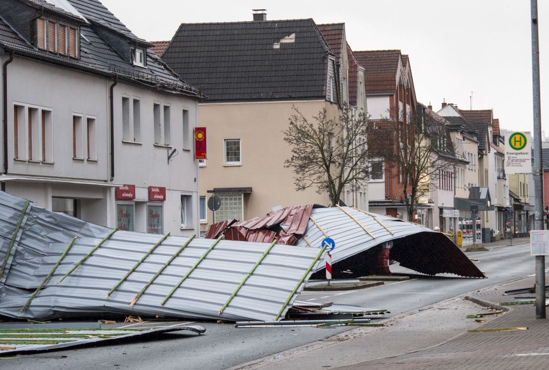A picture taken on January 18, 2018 shows metal roofing sheets from a supermarket blocking a road in Menden, western Germany, as the region is hit by the storm named "Friederike".
