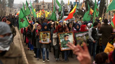 Syrian Kurds carry portraits of the Kurdistan Workers Party (PKK) leader, Abdullah Ocalan, in the town of Jawadiya on Thursday to support the region of Afrin.