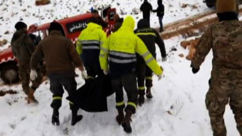 Emergency workers remove the bodies of Syrians found inside Lebanon in a mountainous region near the border. 