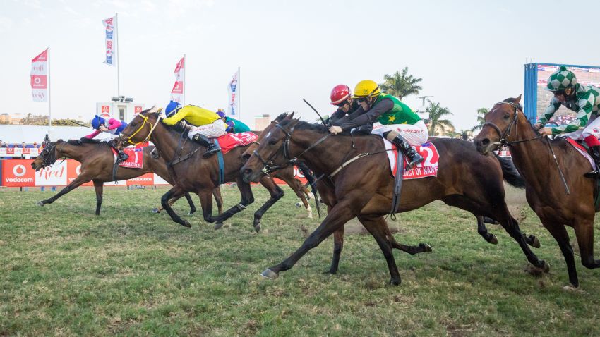Jockey Bernard Fayd'Herbe (L) wins the Durban July race riding Marinarseco at the Greyville Race Course in Durban on July 1, 2017. 
The Durban July horse race is the biggest horse racing event on the African continent and a high social event where South African celebrities dress up and watch the race. It attracts close to 100,000 spectators. / AFP PHOTO / RAJESH JANTILAL        (Photo credit should read RAJESH JANTILAL/AFP/Getty Images)