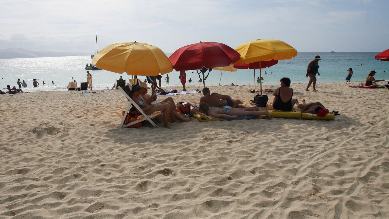 A 2007 image shows tourists sunbathing at Doctor Cave beach in Montego Bay.