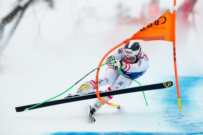 <strong>Going, going...: </strong>Austrian Patrick Schweiger tangles with a gate during the infamous race, the scariest and hairiest on the World Cup circuit.