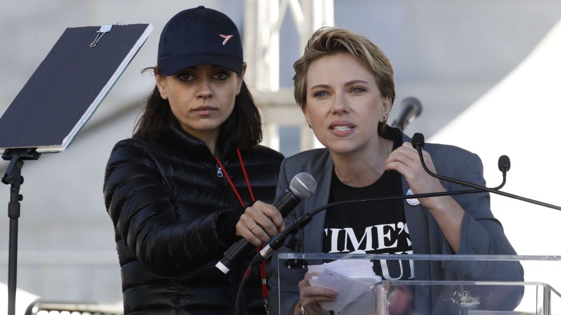 Scarlett Johansson, right, speaks as Mila Kunis holds a microphone for her at the LA Women's March.