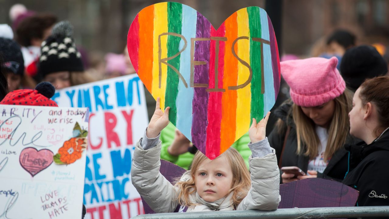 A girl holds up a sign during a rally attended by thousands of demonstrators at Cambridge Commons in Boston, Massachusetts on January 20, 2018.