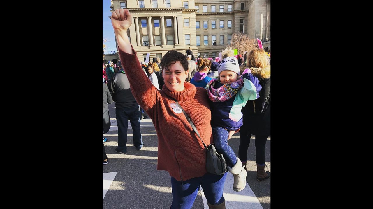 Rachel Baxa and her 2-year-old daughter, Georgia, raise their fists during a women's march in Boise, Idaho, on Sunday. "This is her second march," Baxa said. "It will not be her last."