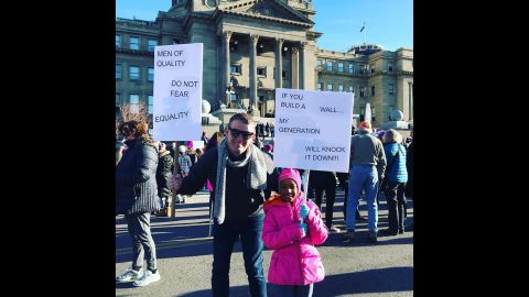 Alex Sloan joins the Women's March with his daughter in Boise, Idaho.